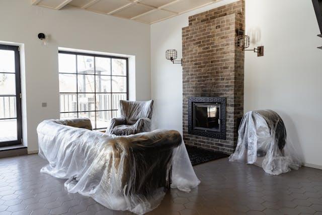 living room with plastic over the furniture